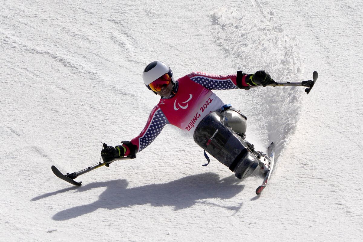 Jasmin Bambur of the United States competes in the men's giant slalom, sitting event at the 2022 Winter Paralympics, Thursday, March 10, 2022, in the Yanqing district of Beijing. (AP Photo/Andy Wong)