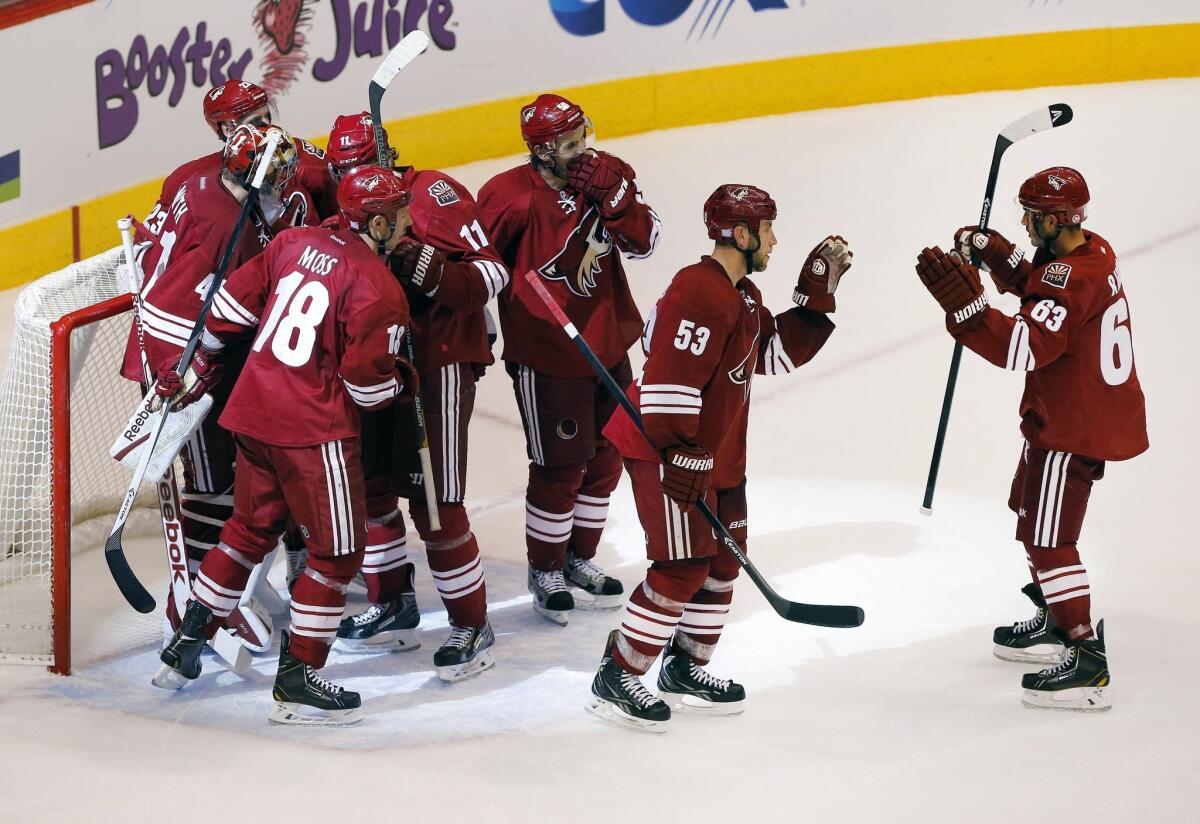 The Phoenix Coyotes celebrate following Saturday's win over the Edmonton Oilers. With a new owner in place, the Coyotes are turning all of their attention back to the ice.