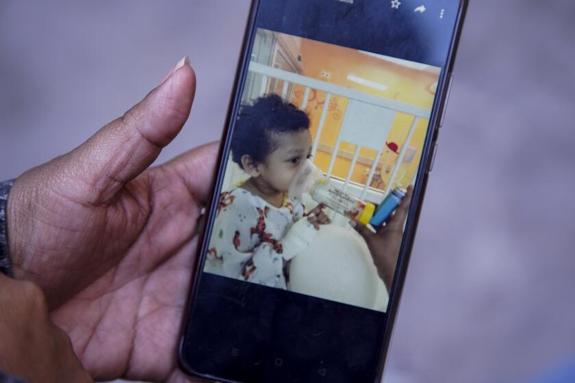 Tijuana, Baja California - October 20: Ana 37, from Guatemala explains her 2-year-old son's medical condition. She is worried he will not be able to get proper treatment in Tijuana Hospital General 1. She hold up cell phone photos of her son Carlitos at Al Otro Lado office on Wednesday, Oct. 20, 2021 in Tijuana, Baja California. (Alejandro Tamayo / The San Diego Union-Tribune)