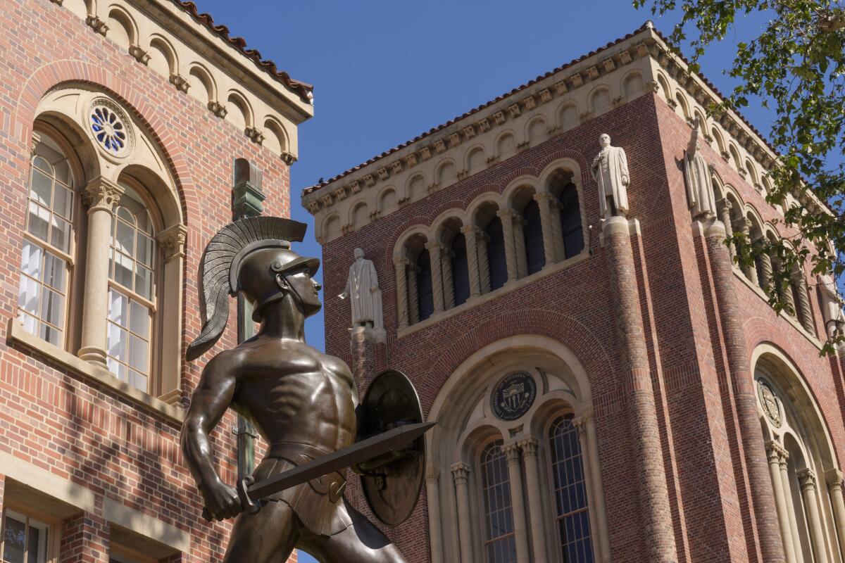 A Trojan statue and buildings on the USC campus.