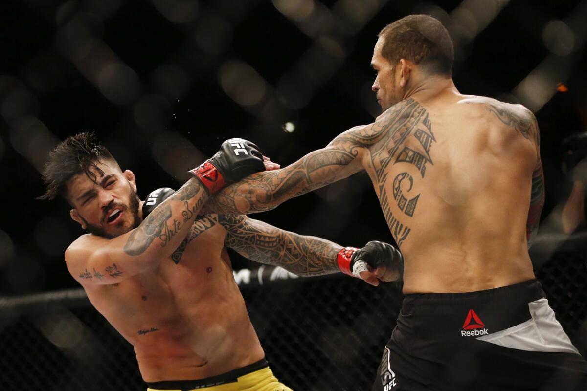 Yancy Medeiros, right, goes on the offensive against Erick Silva during their welterweight fight at UFC 212.