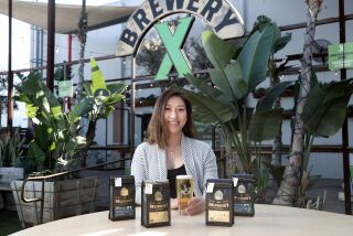 Amy Tang, Sir Owlverick's Coffee owner, poses for a portrait at Brewery X in Anaheim. Sir Owlverick's Coffee has collaborated with Brewery X to launch a new flavor called Hop n' Brew, in celebration of Lunar New Year. (Kevin Chang / TimesOC)