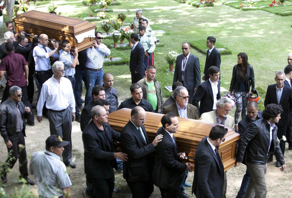 Relatives and friends carry the remains of Monica Spear and her former husband, Thomas Henry Berry, at the East Cemetery in Caracas, Venezuela.