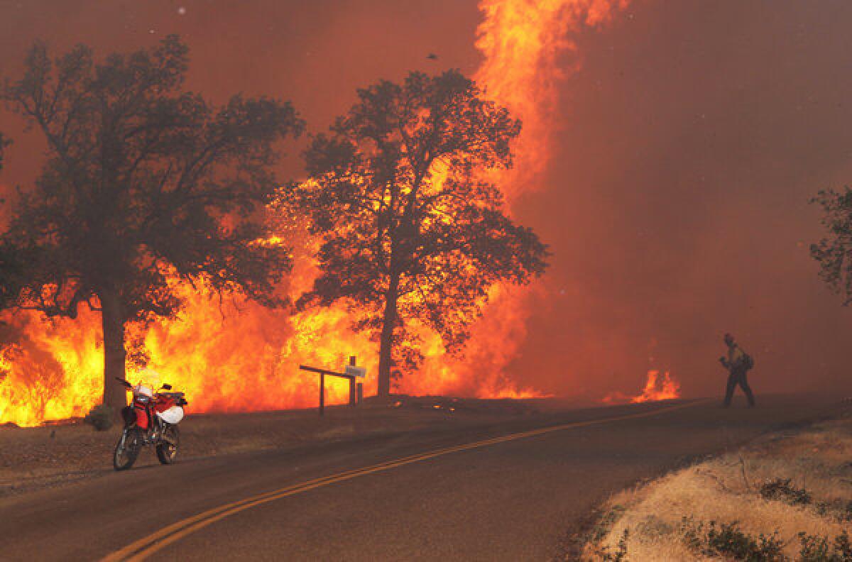 A firefighter works the Clover fire Sept. 9, 2013, on Gas Point Road in Anderson, Calif.