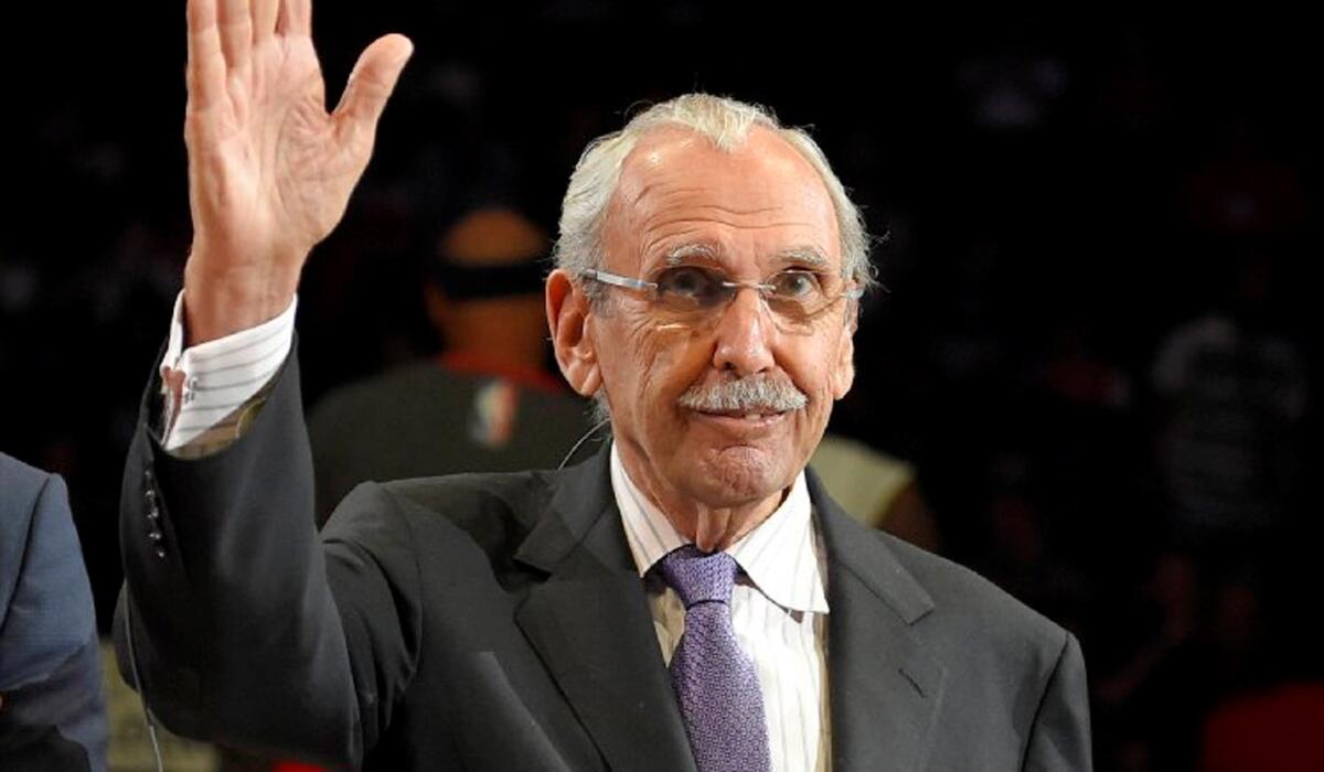 Ralph Lawler, television and radio voice of the Los Angeles Clippers, waves to fans as he is honored during halftime of a game against the Wizards.