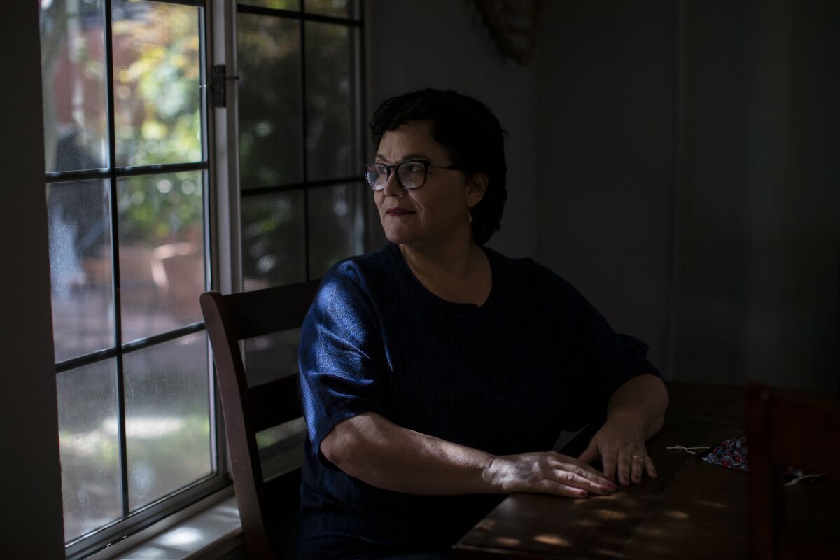 Bertha Castro Valdez, an activist in Lodi, sits at her window.