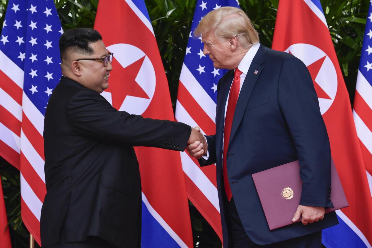 North Korean leader Kim Jong Un and President Trump shake hands at the conclusion of their meetings at the Capella resort on Sentosa Island in Singapore in June.