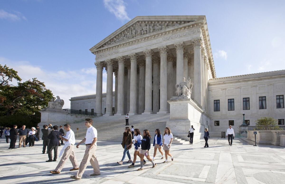 In this Oct. 14, 2014, file photo, people walk outside the Supreme Court in Washington. The Supreme Court is starting a new term on Oct. 5, 2015.
