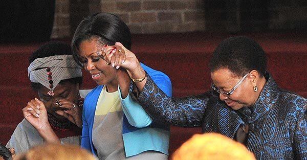 First Lady Michelle Obama arrives with Nelson Mandela's wife, Graca Machel, in Soweto, South Africa. Speaking at Regina Mundi church, once a haven for activists fighting white-minority rule, Obama invoked the memory of leaders of the American civil-rights movement and South Africa's liberation struggle to encourage young leaders.