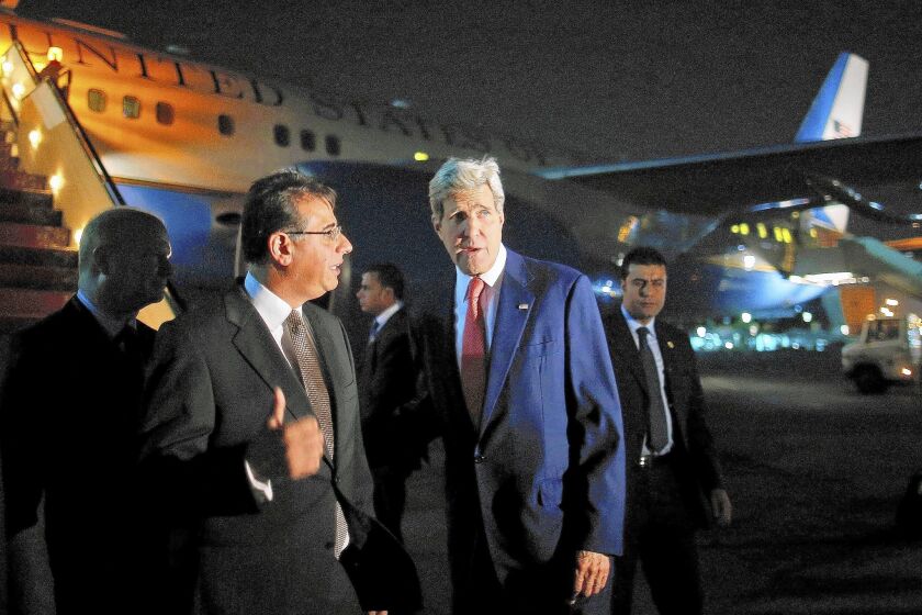 U.S. Secretary of State John F. Kerry, right, is met by the Egyptian foreign minister's protocol chief, Nabil Habashi, as he arrives in Cairo to help revive a proposal for a cease-fire in Gaza.