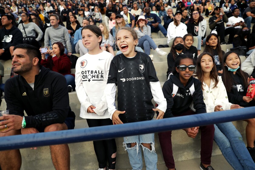 Young soccer players, including Parker Schumacher and Taylor Mendoza, standing from left, attend the NWSL Challenge Cup