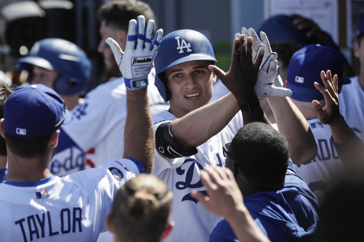 Dodgers shortstop Corey Seager is congratulated by teammates after hitting a home run during the fourth inning of Thursday's 12-5 victory over the Arizona Diamondbacks.