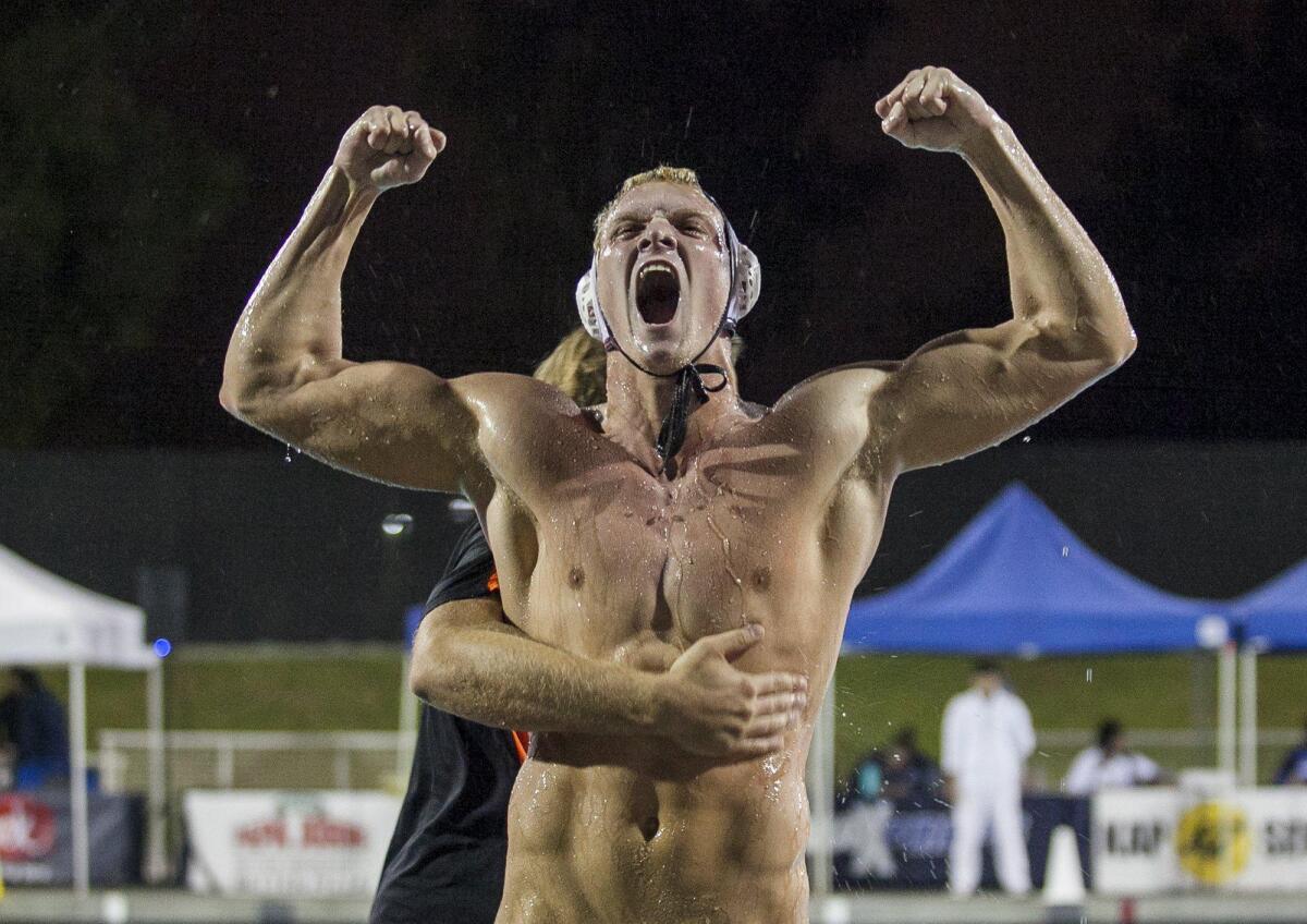 Huntington Beach’s Ethan Wojciechowski celebrates as his head coach Sasa Branisavljevic gives him a hug following 7-6 win over Harvard Westlake on November 16.