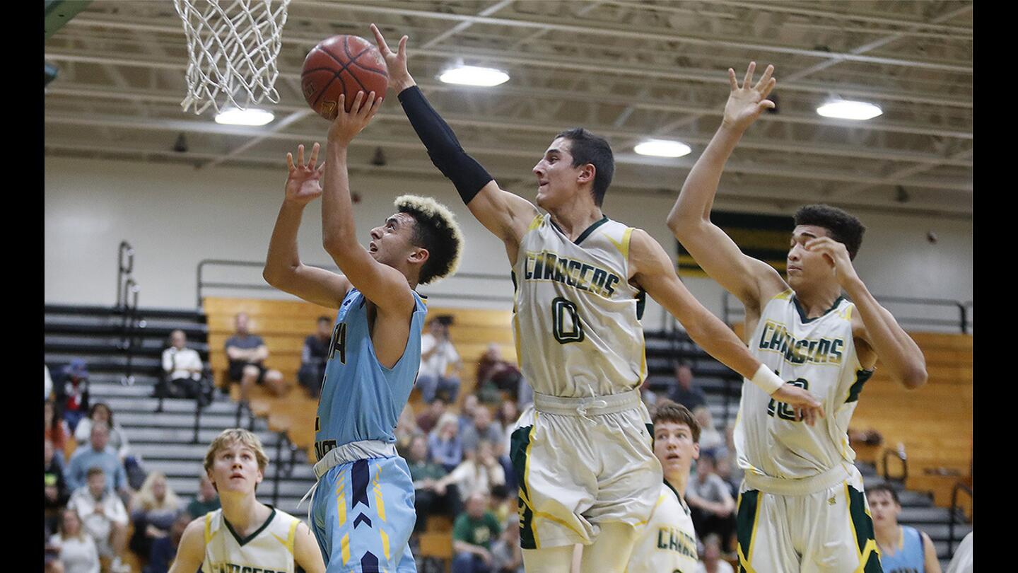 Marina's Peter Serour goes up for a shot as Edison's David Atencio attempts to block him during a Sunset League game on Friday, January 5.