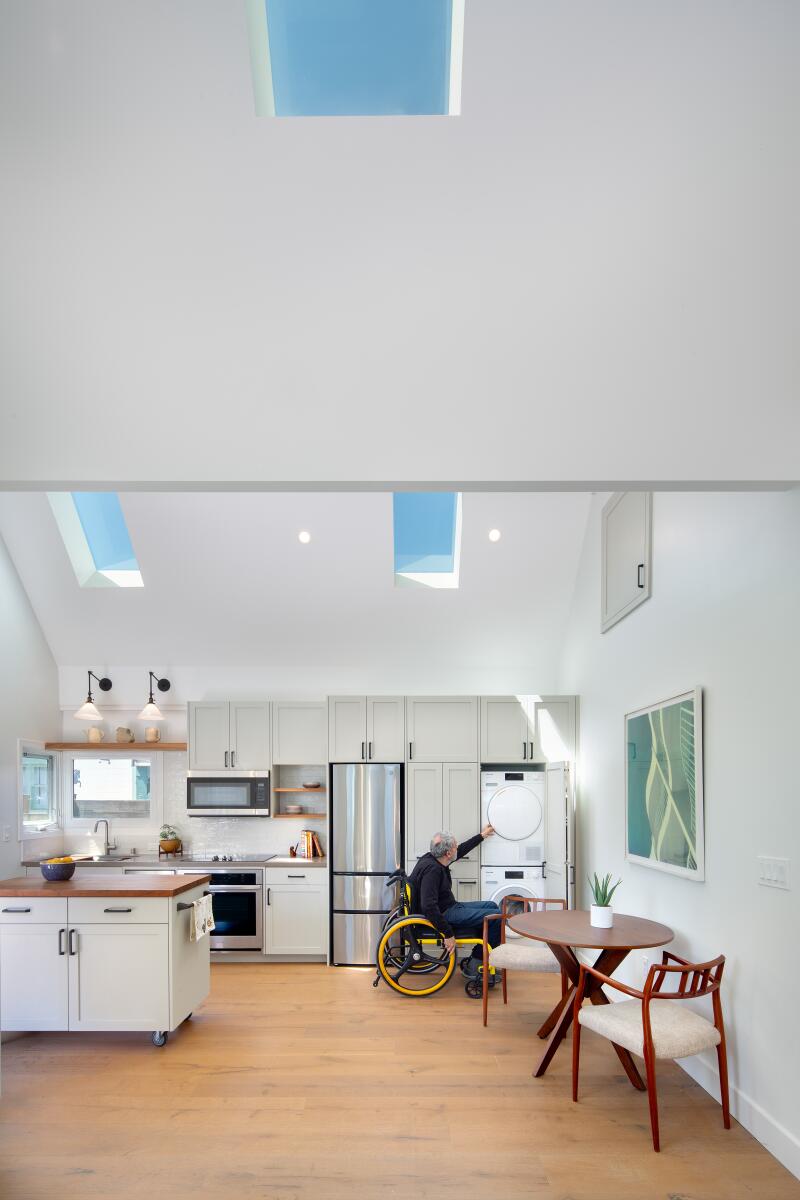 Architect Rachel Allen's husband, Gary Cannone, in the kitchen, which is designed for easy access.