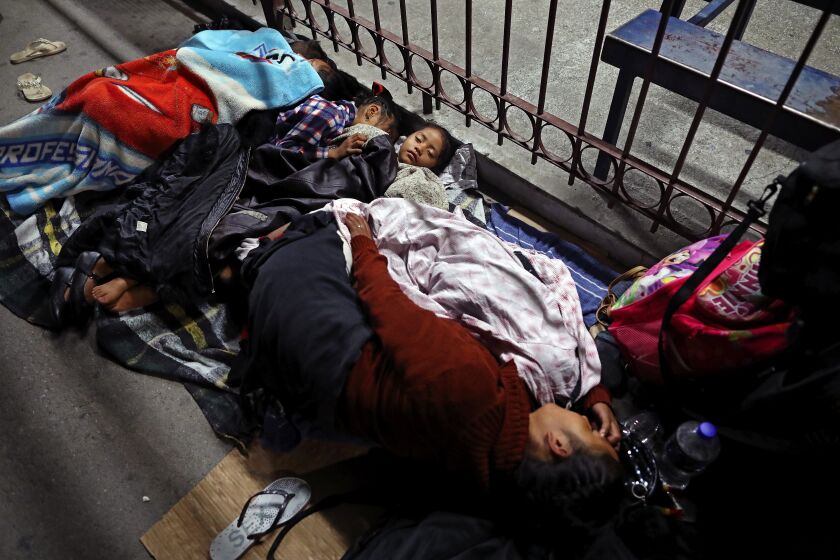 Gary Coronado  Los Angeles Times Frustration on the border A migrant family including three small children camps near a border bridge in Ciudad Juarez, Mexico. Those seeking asylum in the U.S. face long waits, stress and uncertainty in half a dozen cities. NATION, A6