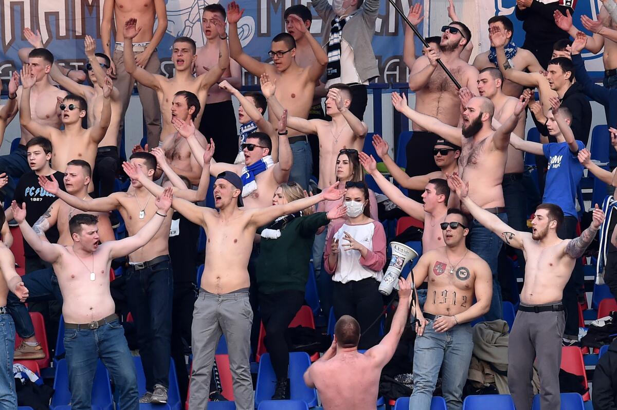 Fans of FC Minsk support their team during the Belarus Championship foolball match between FC Minsk and FC Dinamo-Minsk in Minsk, on March 28, 2020. - In stark contrast to leagues elsewhere on the European continent, the Belarus championship continues. (Photo by Sergei GAPON / AFP) (Photo by SERGEI GAPON/AFP via Getty Images)