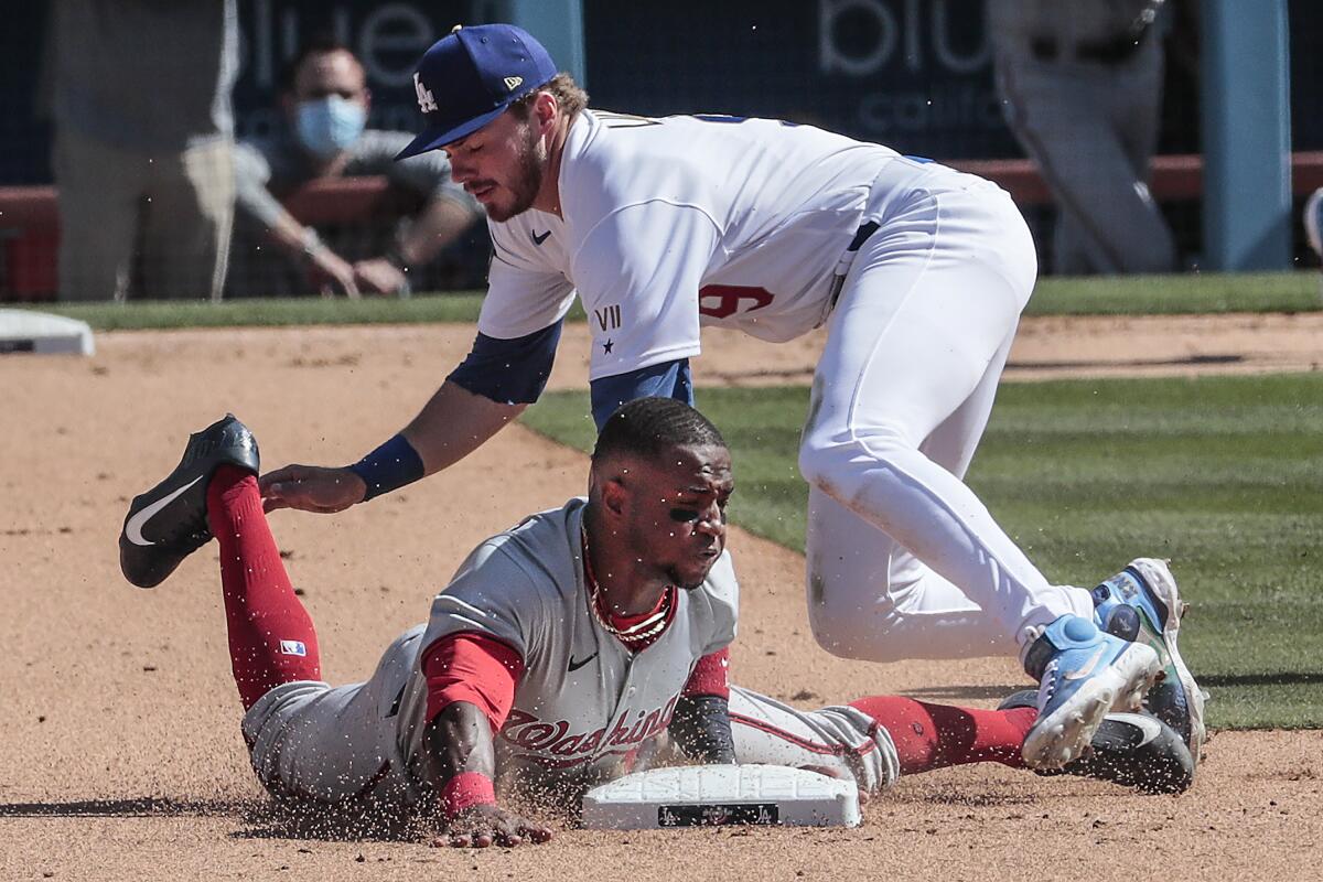 Washington's Victor Robles is tagged out on a steal attempt by Gavin Lux.