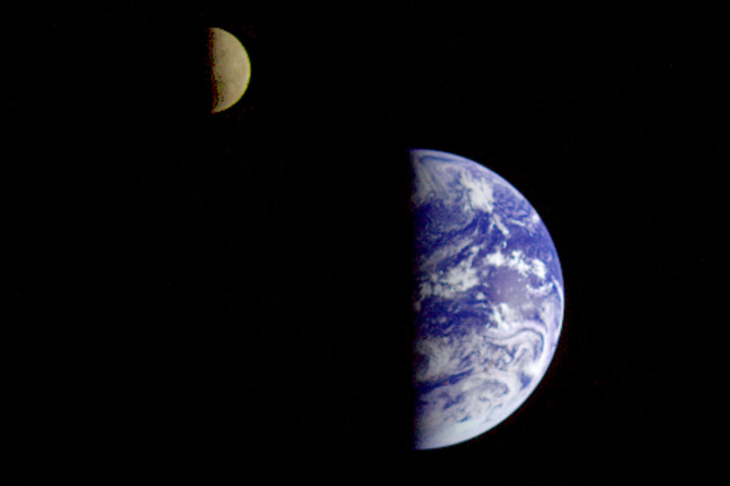 Earth and the moon are seen from a distance in space