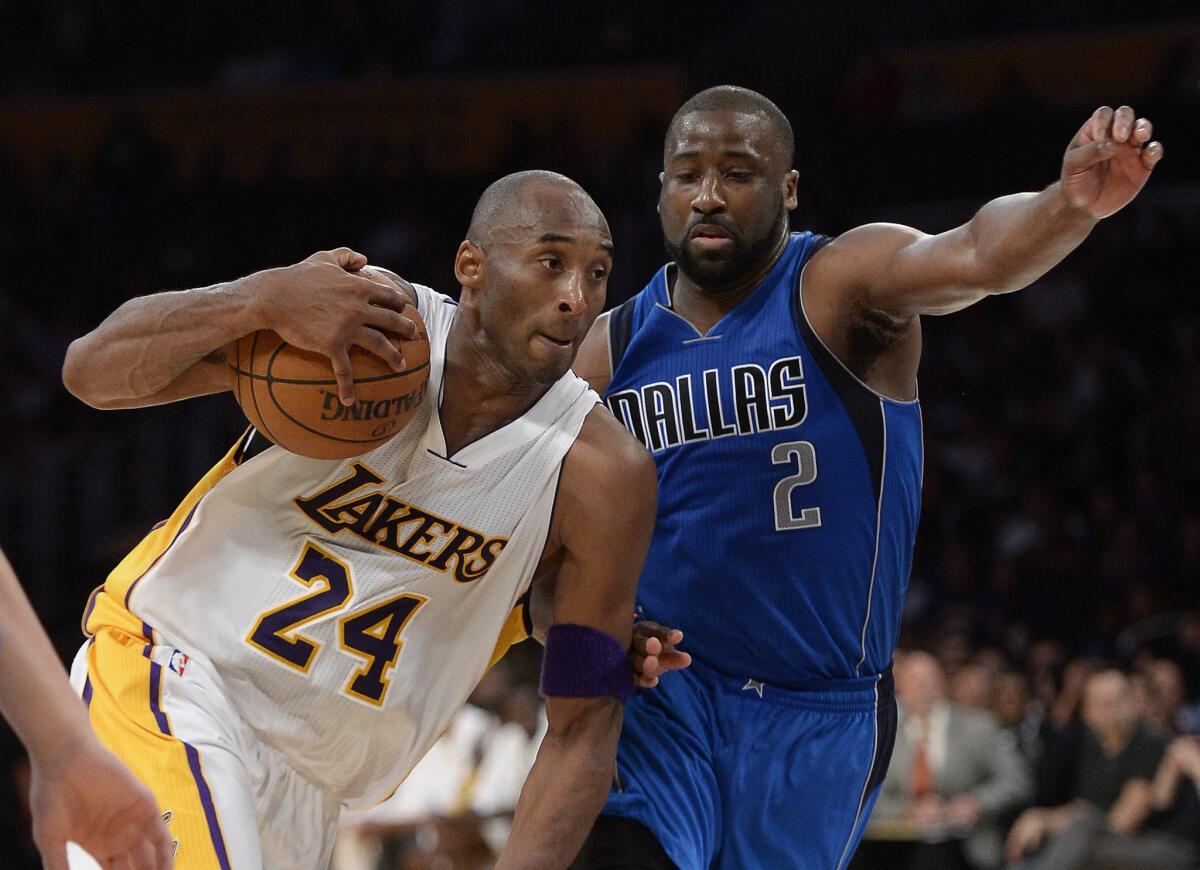 Lakers forward Kobe Bryant dribbles past Mavericks guard Raymond Felton in the second half.
