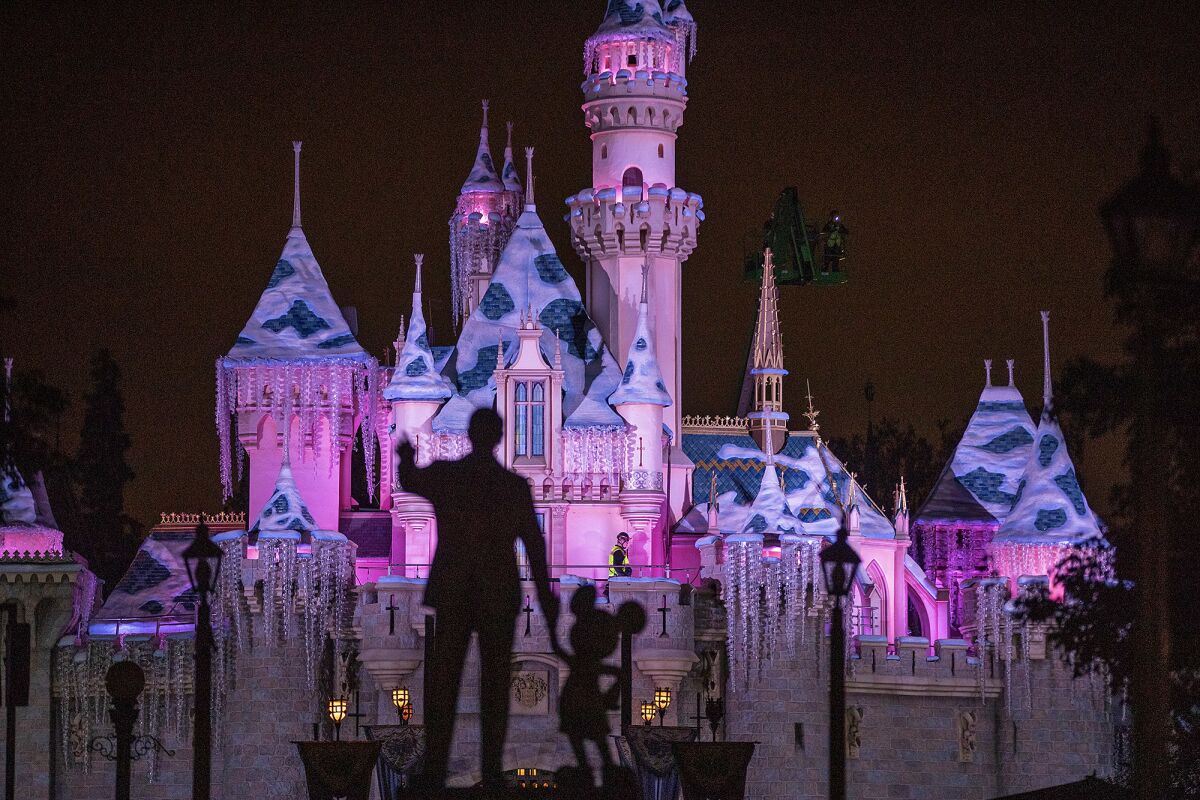 Disneyland workers decorate Sleeping Beauty Castle for Christmas last November. The castle's roof has been replaced and it has been repainted with extra bright colors.