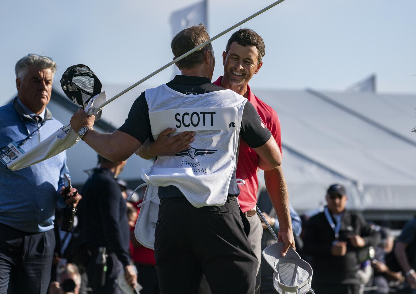 Adam Scott hugs his caddie John Limanti after winning the Genesis Invitational at Riviera Country Club on Feb. 16, 2020.