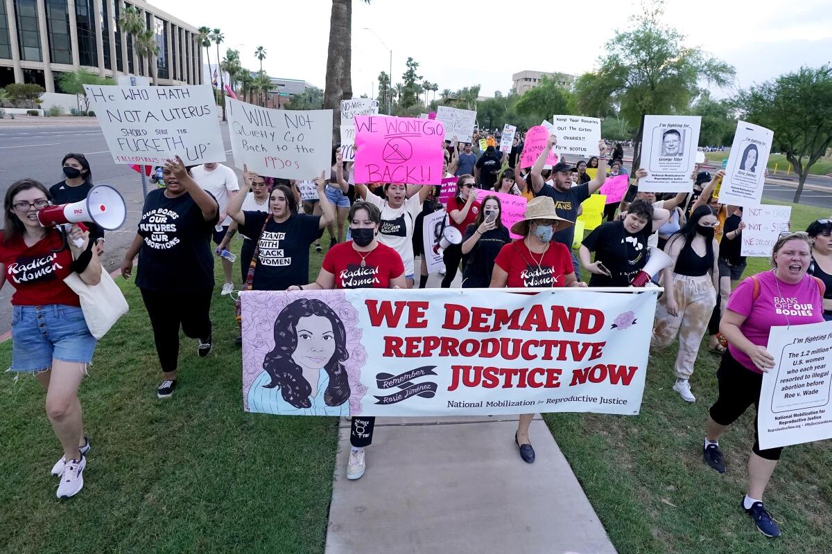 FILE - Thousands of protesters march around the Arizona Capitol in protest after the Supreme Court decision to overturn the landmark Roe v. Wade abortion decision Friday, June 24, 2022, in Phoenix. A stunning abortion ruling this week in April 2024, has supercharged Arizona’s role in the looming fall election. (AP Photo/Ross D. Franklin, File)