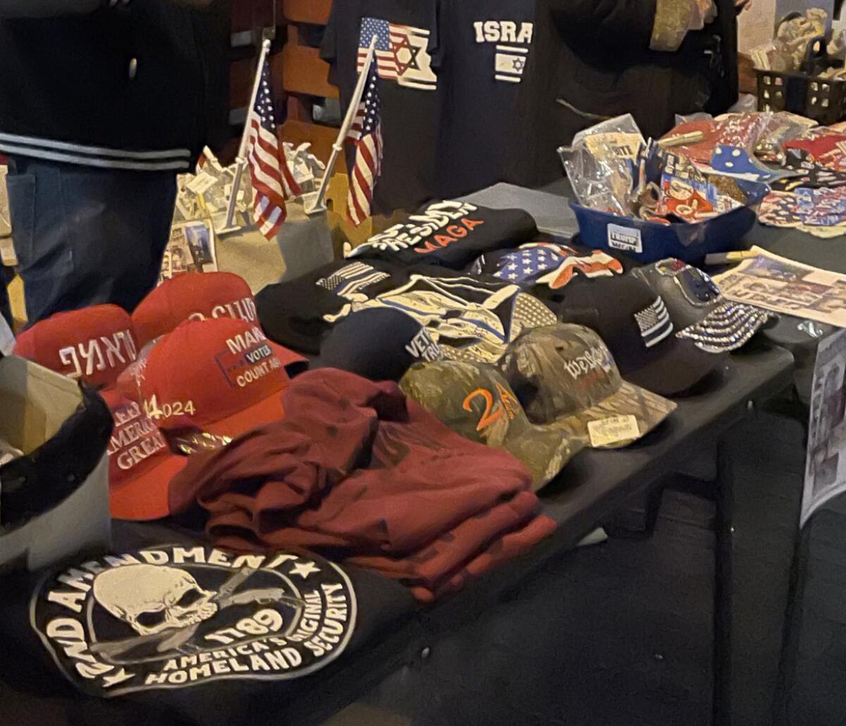 A vendor at Hospitality Night in Laguna Beach on Dec. 3 displayed right-wing political items.