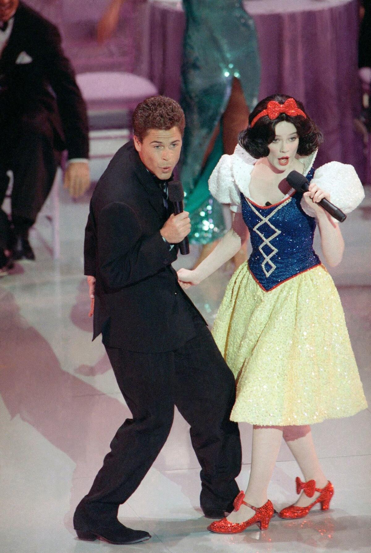 Rob Lowe, left, and Eileen Bowman in 1989. Walt Disney Co. filed a lawsuit charging unauthorized use of its Snow White character in an opening routine. The suit was later dropped.