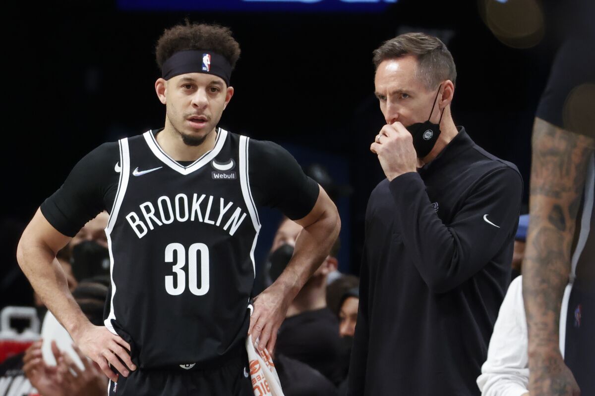 Brooklyn Nets guard Seth Curry (30) talks to head coach Steve Nash during the first half of an NBA basketball game against the Sacramento Kings, Monday, Feb. 14, 2022, in New York. (AP Photo/Corey Sipkin)