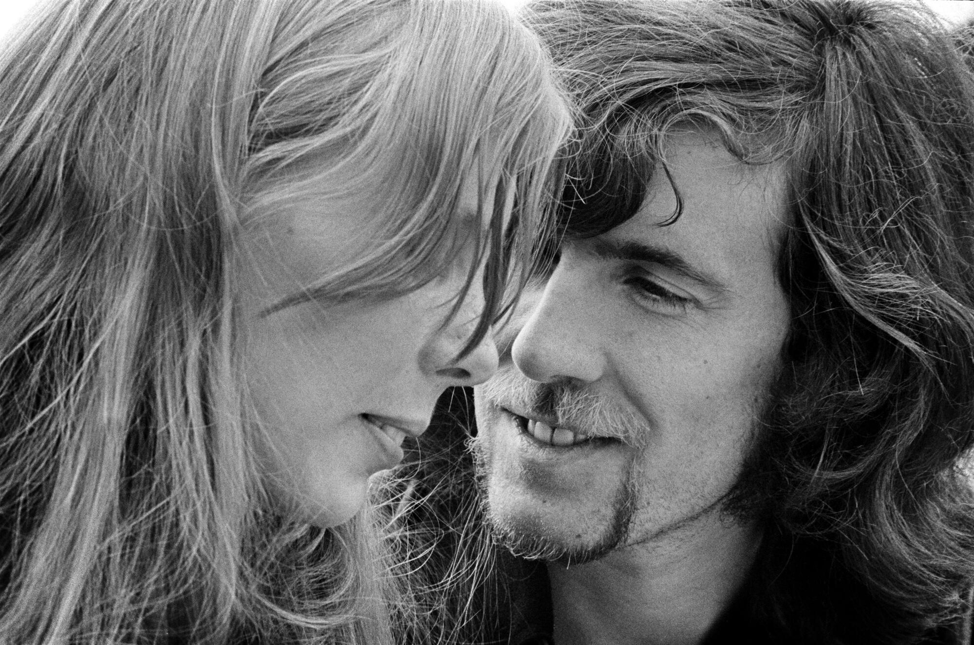 Joni Mitchell and Graham Nash, close up, in black and white.