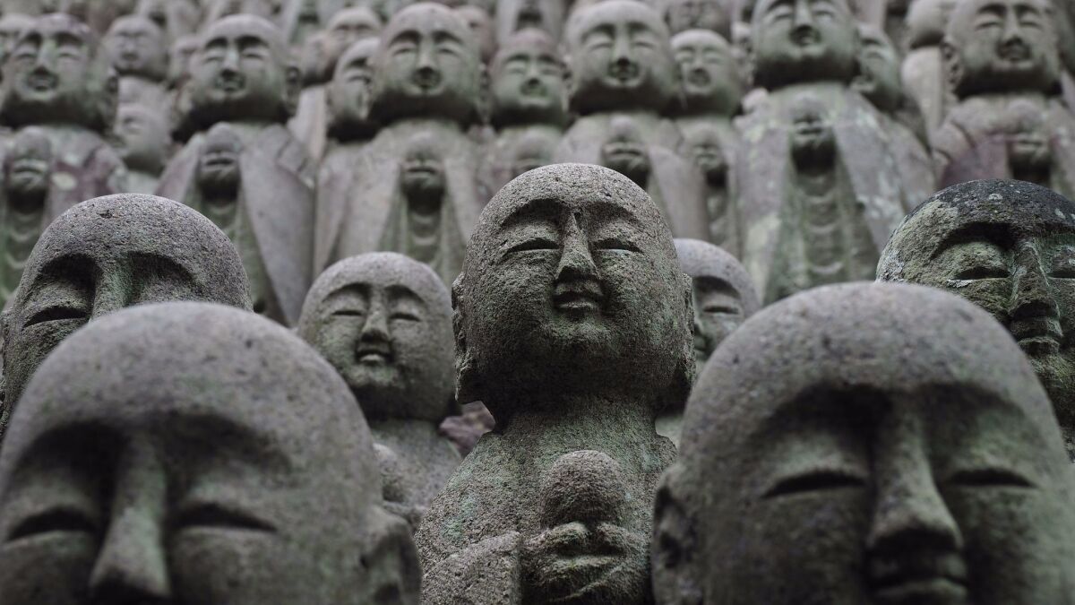 The Hase-dera temple in Kamakura is lined with statues of the deity Jizo, protector of those who need extra care.