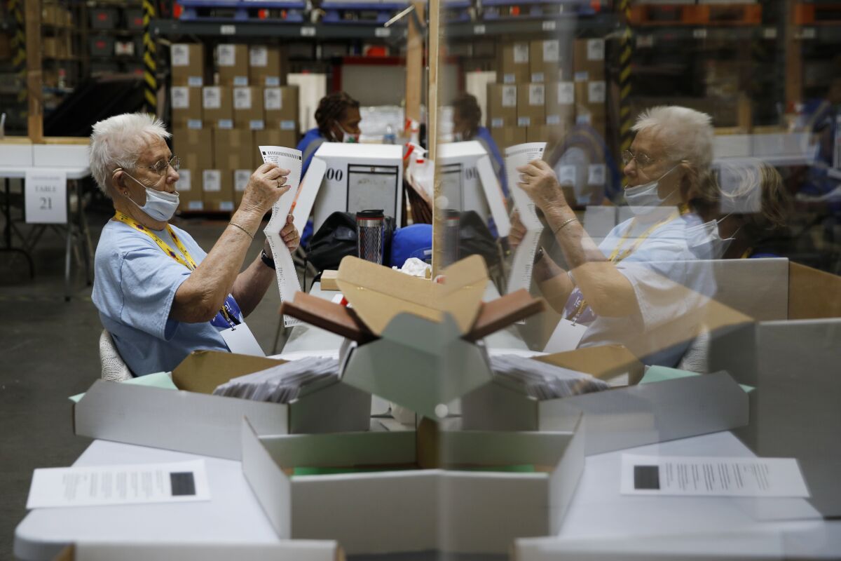 FILE - In this June 9, 2020, file photo, election workers process mail-in ballots during a nearly all-mail primary election in Las Vegas. (AP Photo/John Locher, File)