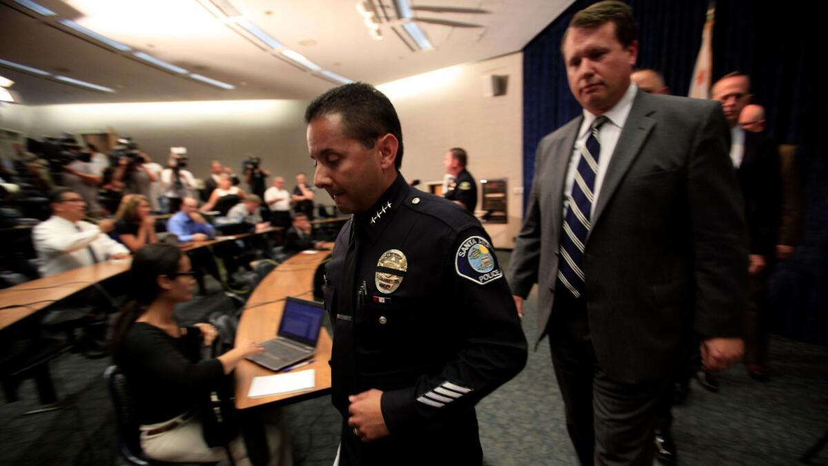 Santa Ana Police Chief Carlos Rojas, center, after a news conference in Anaheim in 2014.