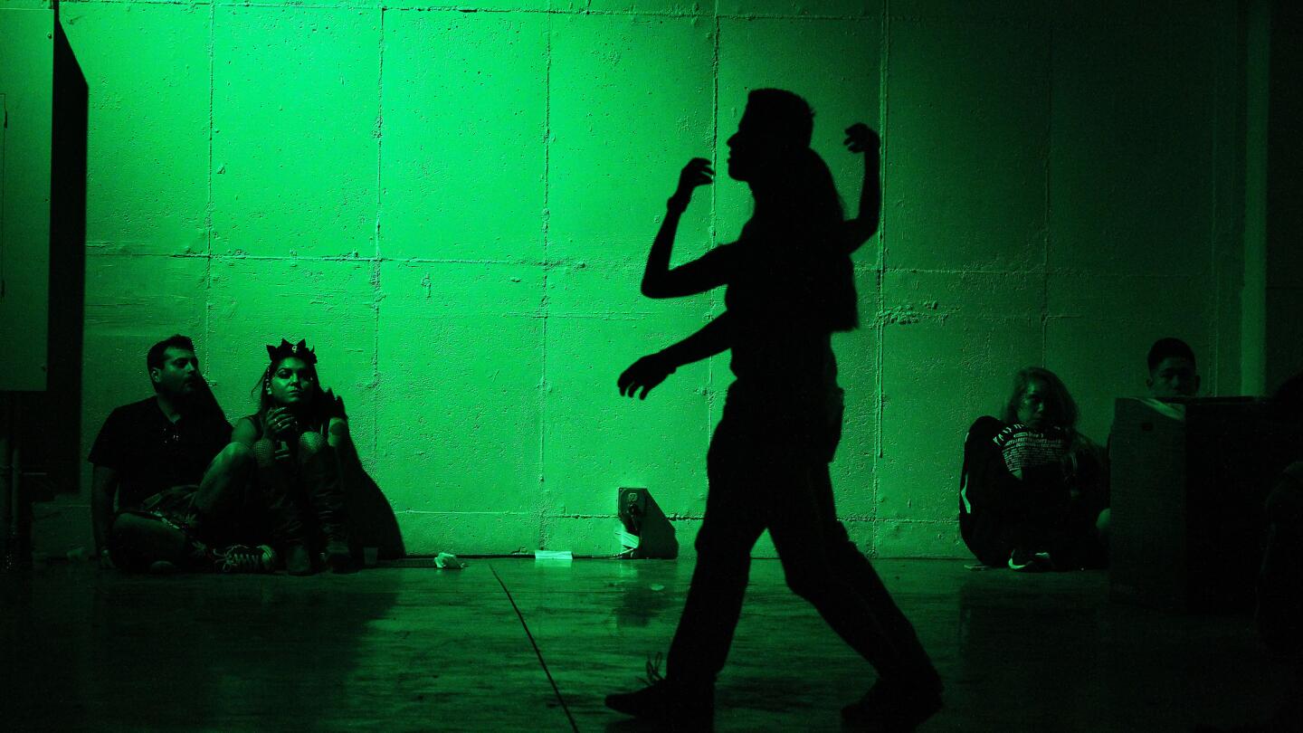 Couples find a quiet place to chill near the 7Up Stage during Hard Day of the Dead at Fairplex in Pomona.