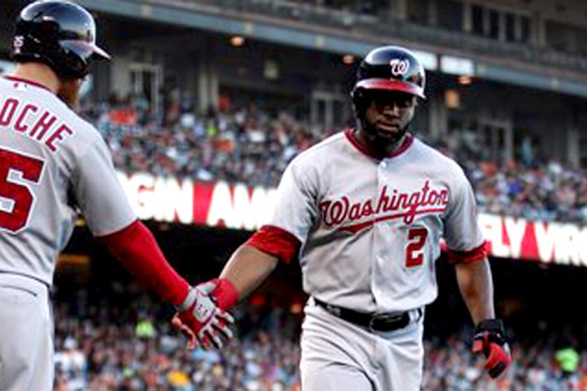 Denard Span (2) in congratulated by Nationals teammate Adam LaRoche (25) after scoring against the Giants during a game in San Francisco on June 9, 2014.