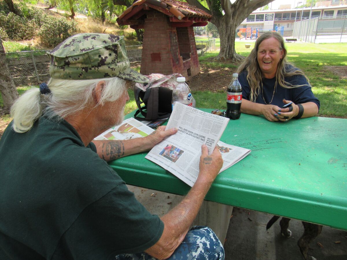 John Jacoby and Naomi Flynn take a break and discuss the news on Wednesday morning at Collier Park.