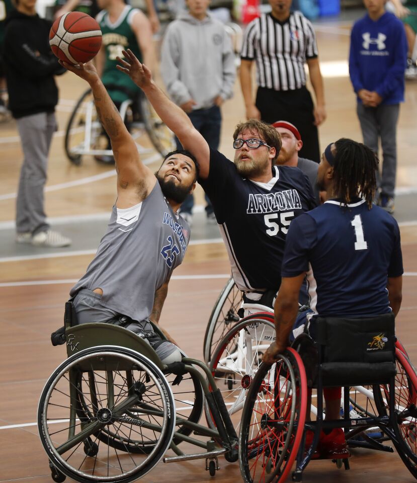 Jorge Salazar, left, of the Naval Medical Center San Diego Wolfpack. goes up for a rebound against Karl Yates from the University of Arizona during the 4th Annual Brad Rich Invitational wheelchair basketball tournament at the Del Mar Fairgrounds on Feb. 9, 2020.