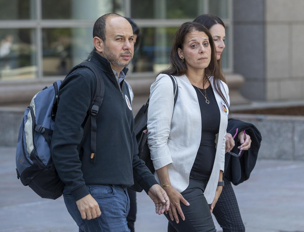 Nancy Iskander and her husband, Karim, leave court in 2022. 