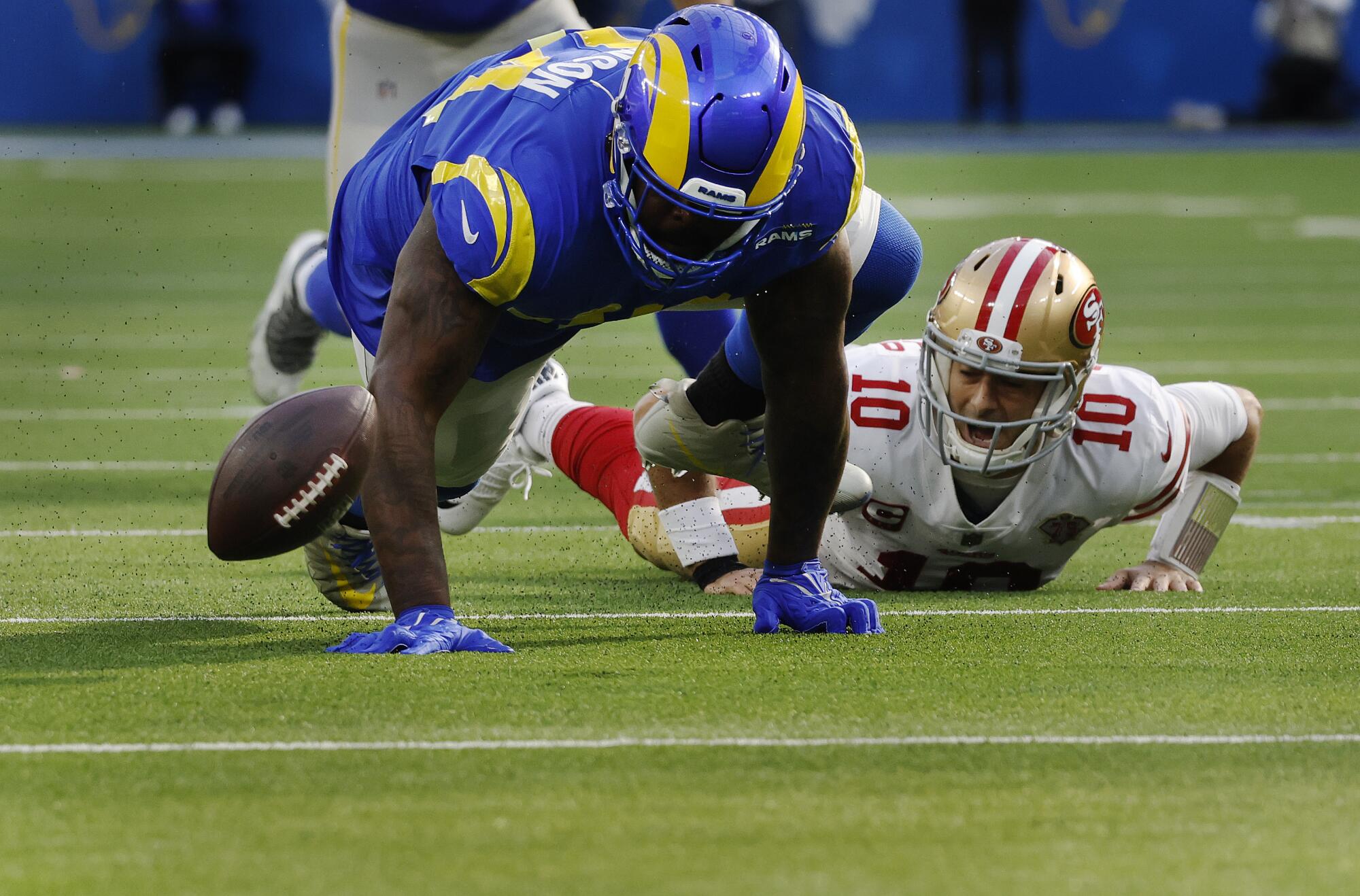 Rams defensive end A'Shawn Robinson (94) forces 49ers quarterback Jimmy Garoppolo (10) to fumble in the first half