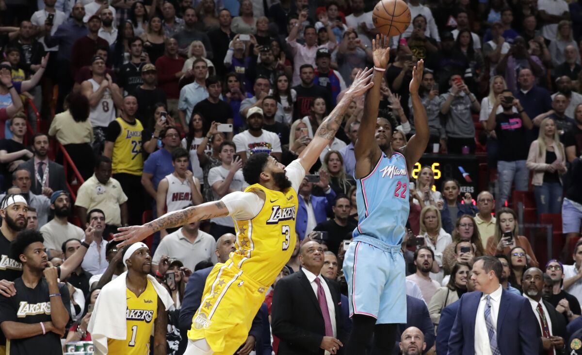 Lakers forward Anthony Davis challenges a last-second shot by Heat guard Jimmy Butler during a game Dec. 13, 2019, in Miami.