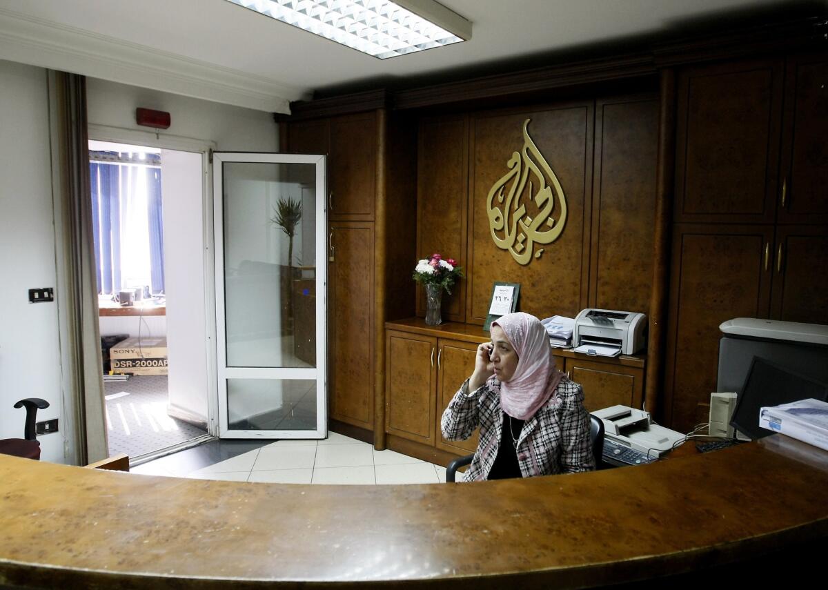 An employee of Al Jazeera talks on the phone at the television channel's now-closed bureau in Cairo.