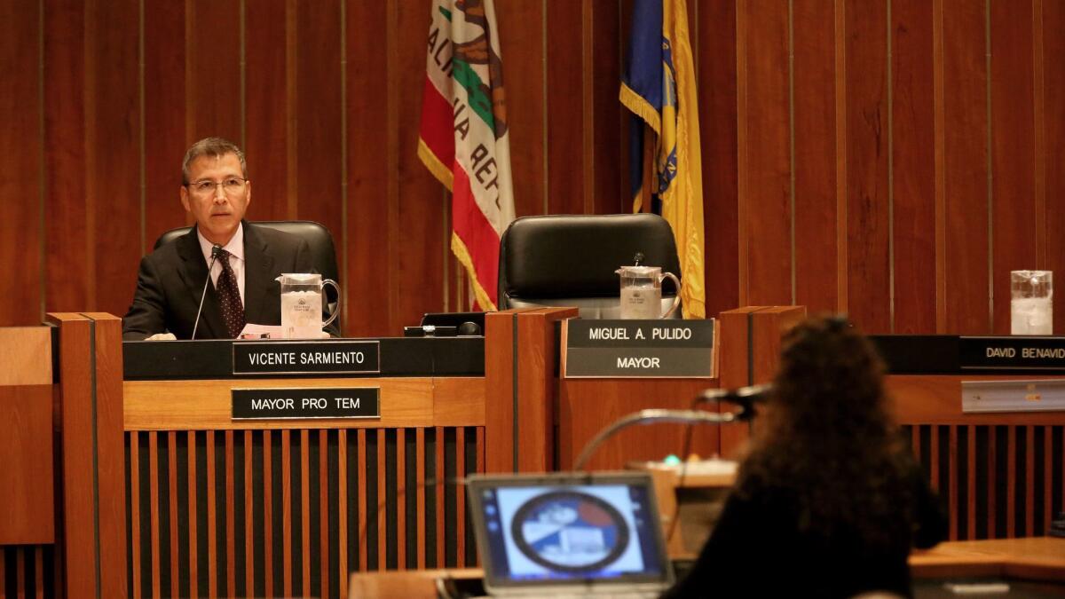 Mayor Pro Tem Vicente Sarmiento listens as Denise Hinojosa speaks about the city becoming a sanctuary city for immigrants who fear deportation under a Trump presidency.