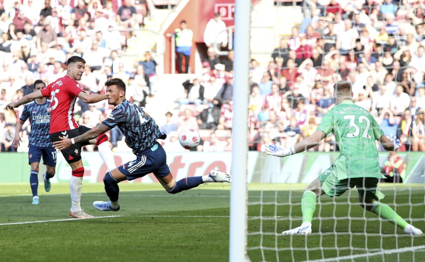 Southampton's Jan Bednarek, left, scores his sides first goal of the game during their English Premier League soccer match against Arsenal at St Mary's, Southampton, England, Saturday, April 16, 2022. (Kieran Cleeves/PA via AP)