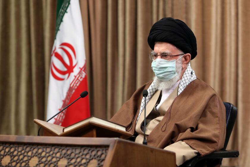 In this picture released by an official website of the office of the Iranian supreme leader, Supreme Leader Ayatollah Ali Khamenei wearing a protective face mask, attends a meeting in Tehran, Iran, Wednesday, April 14, 2021. Khamenei said Wednesday that the offers being made at the Vienna talks over his country's tattered nuclear deal "are not worth looking at." (Office of the Iranian Supreme Leader via AP)