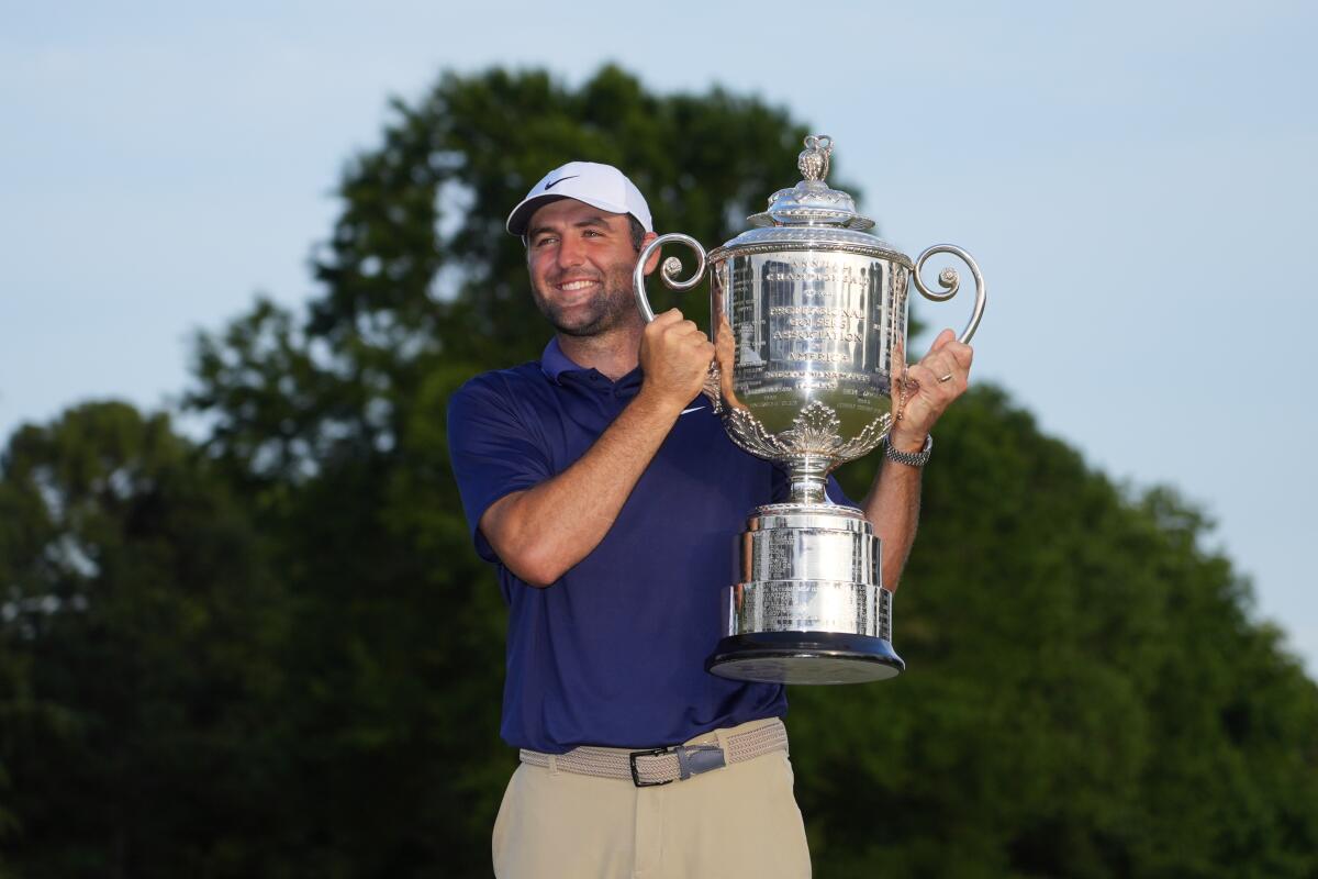Scottie Scheffler holds the Wanamaker trophy after winning the PGA Championship.