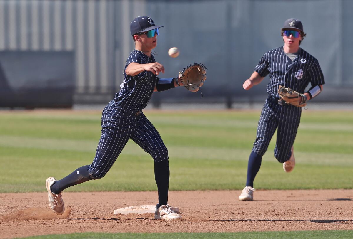 Newport Harbor shortstop Grant Horsley throws to first for an out during the Battle of the Bay baseball game on Wednesday.
