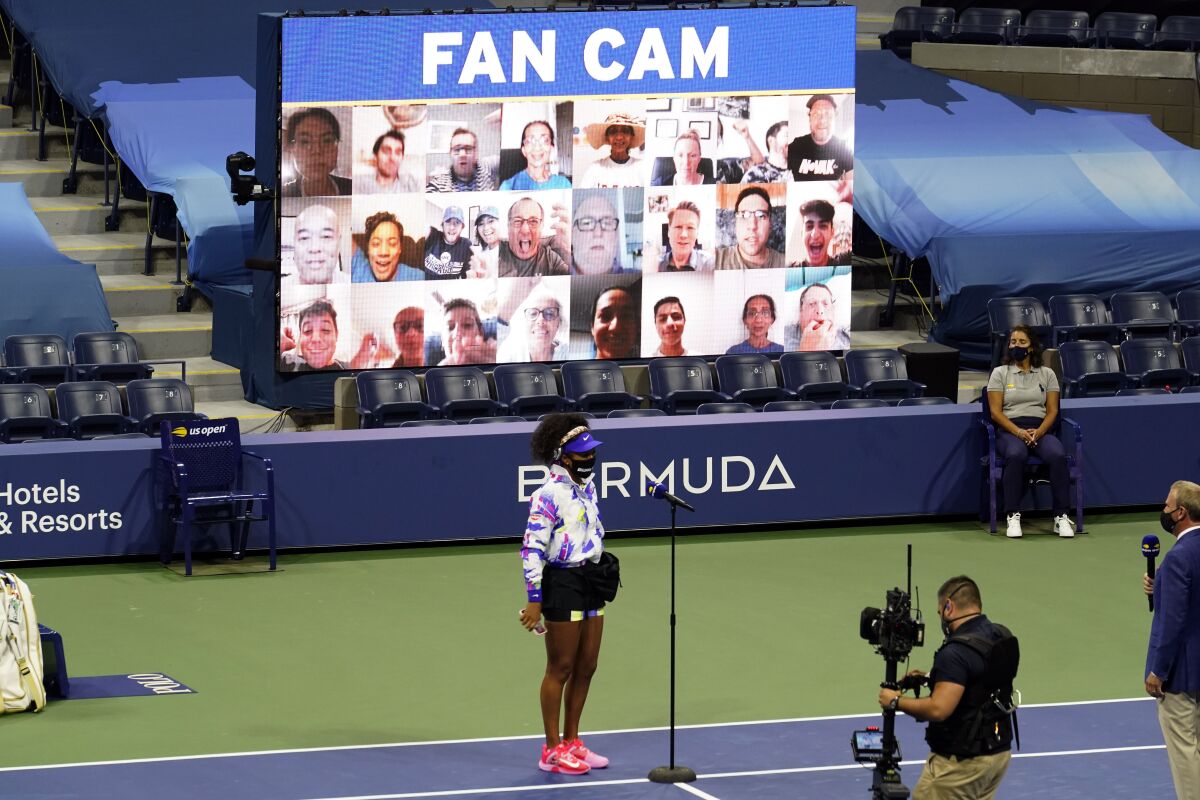Naomi Osaka, of Japan, wears a mask in honor of Breonna Taylor as she speaks in front of a video display of fans before facing Misaki Doi, of Japan, during the first round of the US Open tennis championships, Monday, Aug. 31, 2020, in New York. (AP Photo/Frank Franklin II)