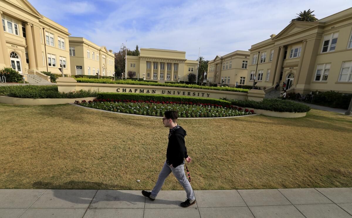A random young man walks on the campus of Chapman University