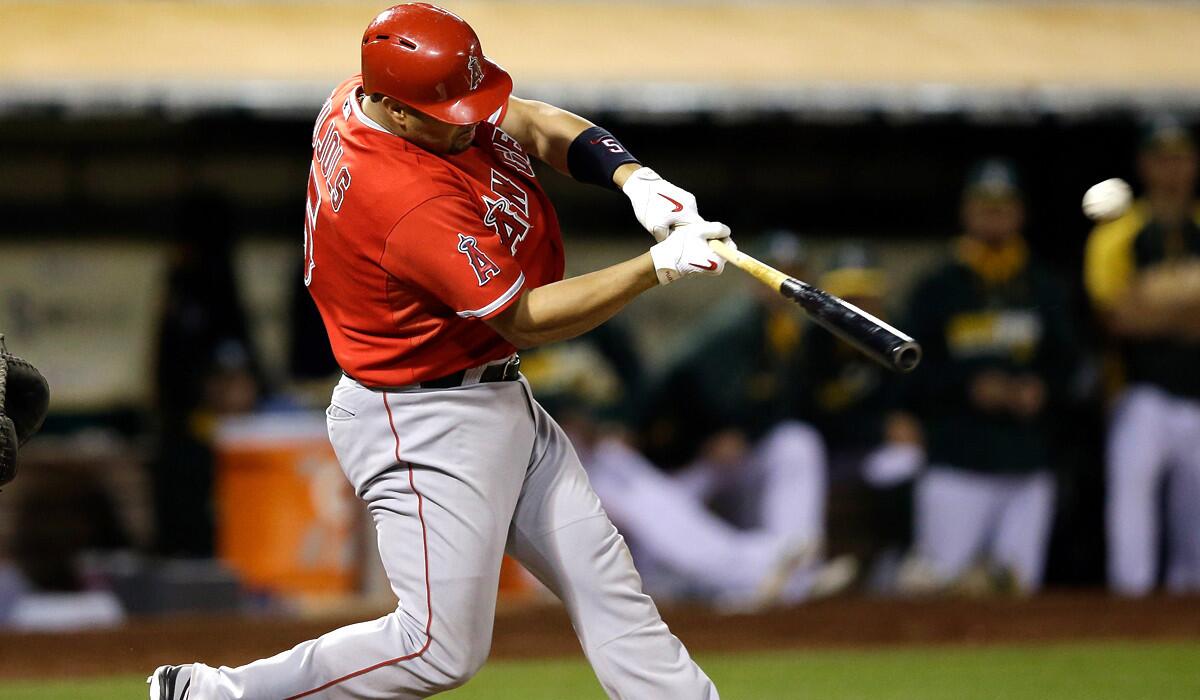 Angels first baseman Albert Pujols connects for a three-run home run in the eighth inning against the A's on Monday night in Oakland.